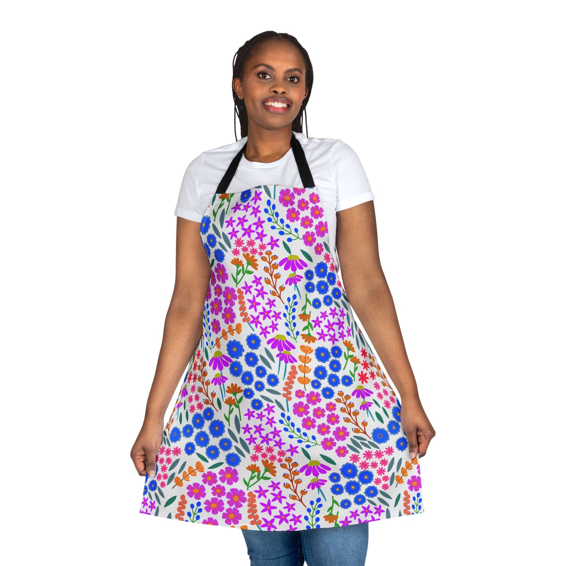 Woman in a Floral Apron smiling, showcasing FireBrook Designs' stylish, stain-free apron made of soft polyester canvas, ideal for cooking or crafting, featuring vibrant floral patterns and a comfortable tie-back closure.