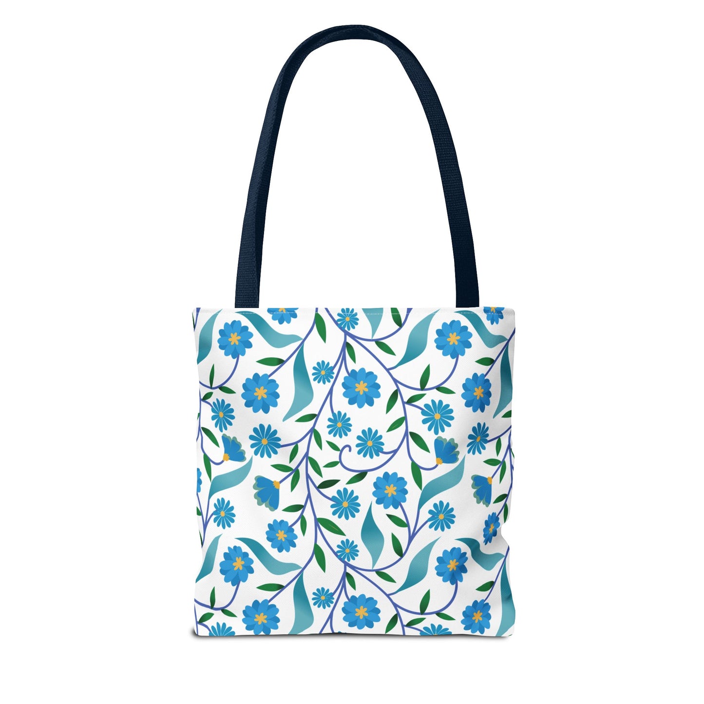 Blue Floral Tote Bag with navy straps, featuring a vibrant pattern of blue blossoms and green leaves on a white background. Perfect for summer outings, offering durability and cheerful design.
