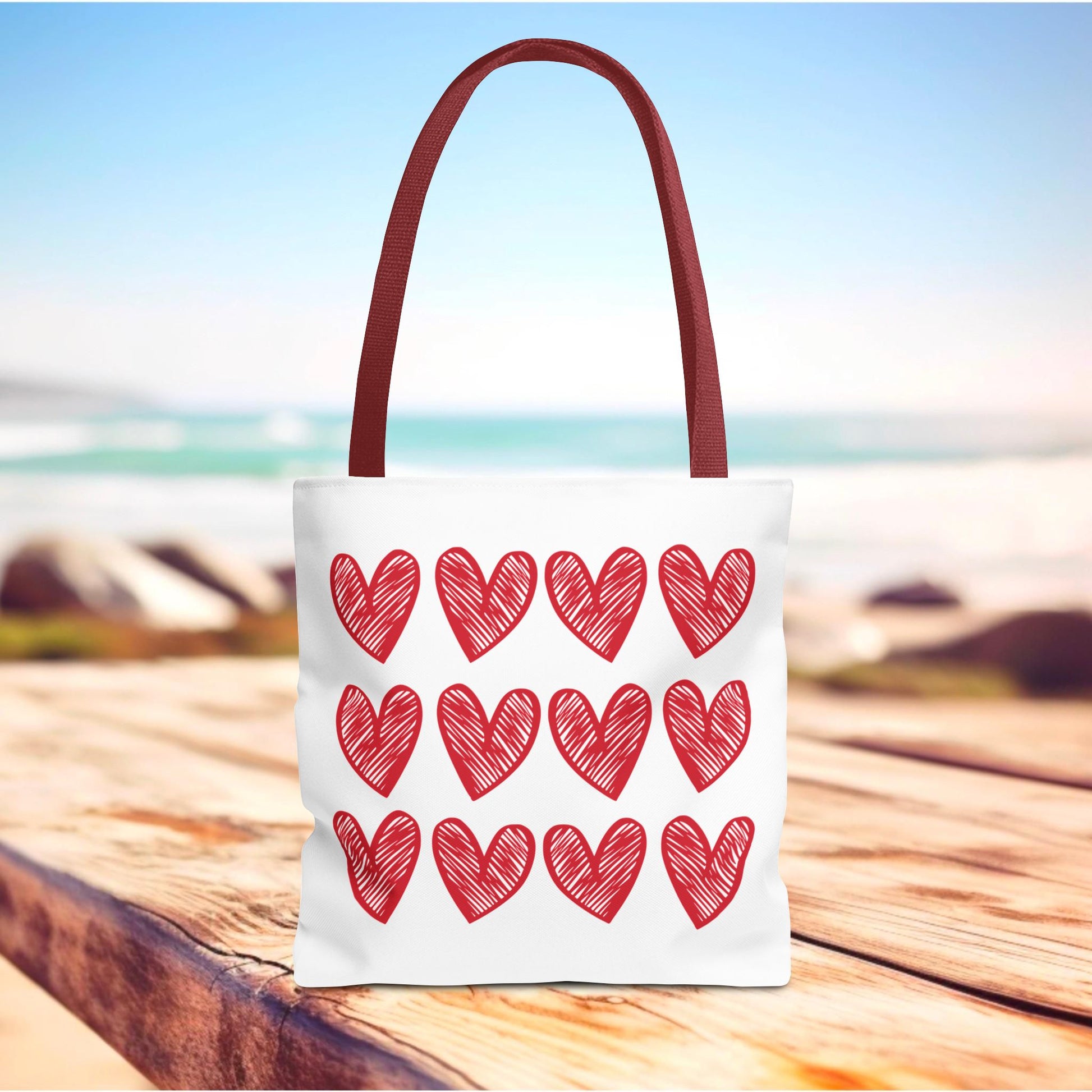 Hearts Tote Bag featuring vibrant red heart patterns, crafted for durability and style. This cute and quirky tote is a perfect accessory for adding charm and joy to everyday outings.