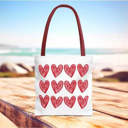 Hearts Tote Bag featuring vibrant red heart patterns, crafted for durability and style. This cute and quirky tote is a perfect accessory for adding charm and joy to everyday outings.