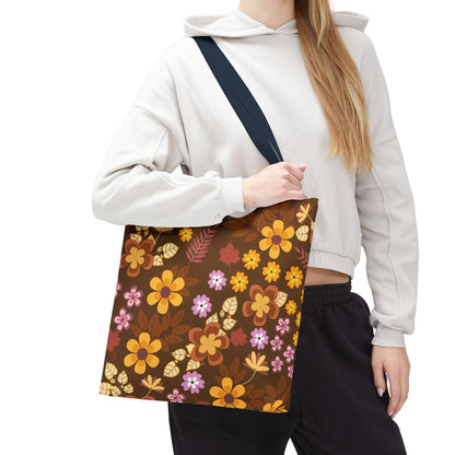 A person models the Floral Tote Bag with a dark brown base and vibrant floral pattern, ideal for summer outings. The tote features durable polyester, reinforced handles, and ample space for essentials.