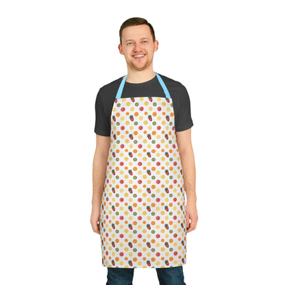 Apron, Fruit Slice Design, 5-Color Straps: A man smiles wearing a vibrant apron adorned with orange, lemon, pineapple, strawberry, and kiwi slices, embodying FireBrook Designs' uplifting style for culinary enthusiasts.