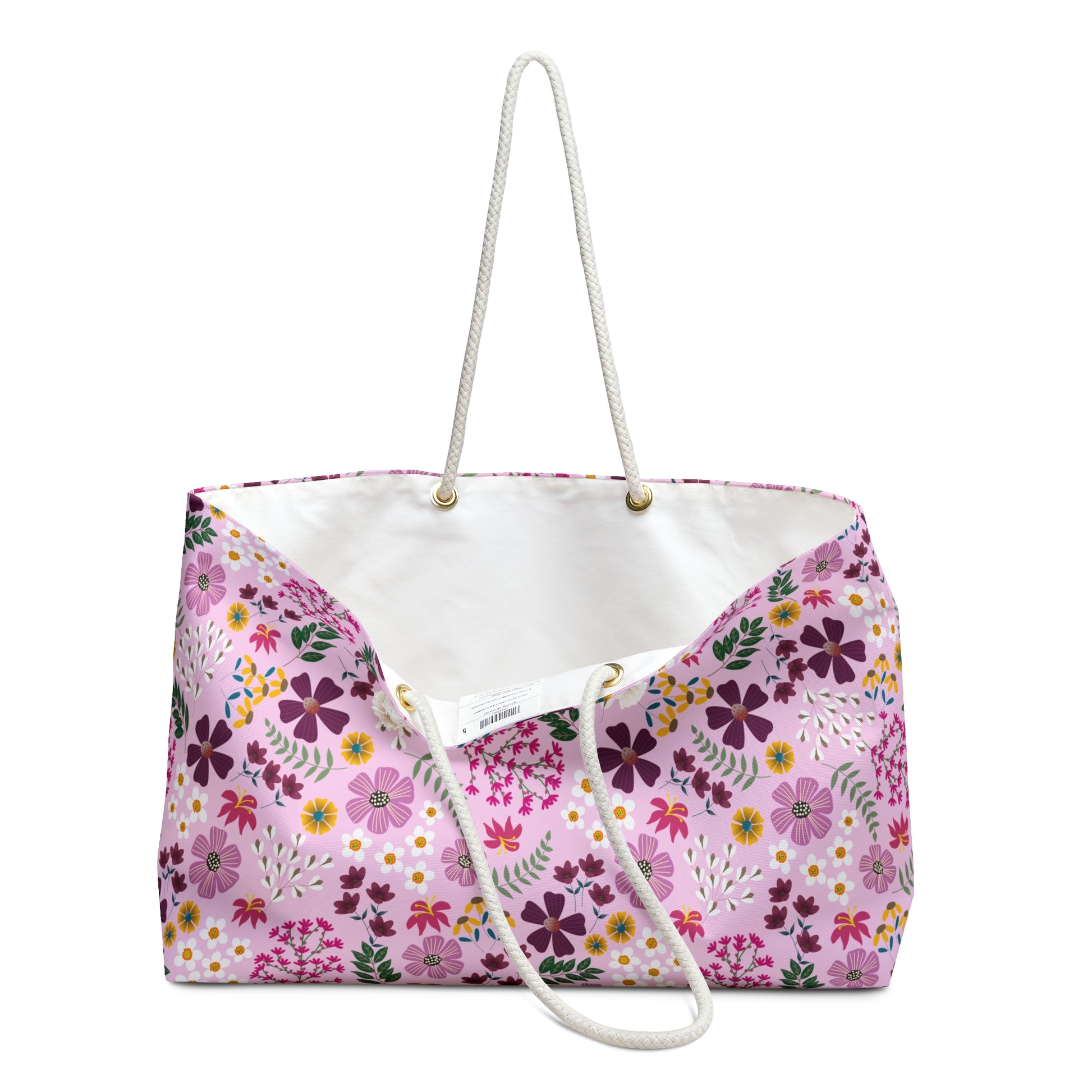 Weekender Bag with a soft pink floral pattern and white rope handles, ideal for stylish travel. Designed for comfort and ease, it embodies FireBrook Essentials' commitment to enhancing joyful, positive experiences.