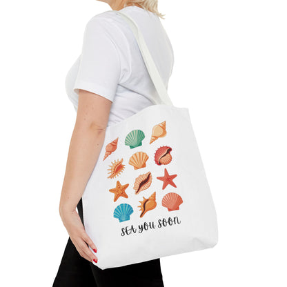 Sea You Soon Sea Shells Tote Bag showcasing a beach-themed design with seashells, embodying a summery vibe. Ideal for beach outings, reflecting FireBrook Essentials' focus on stylish, uplifting products.