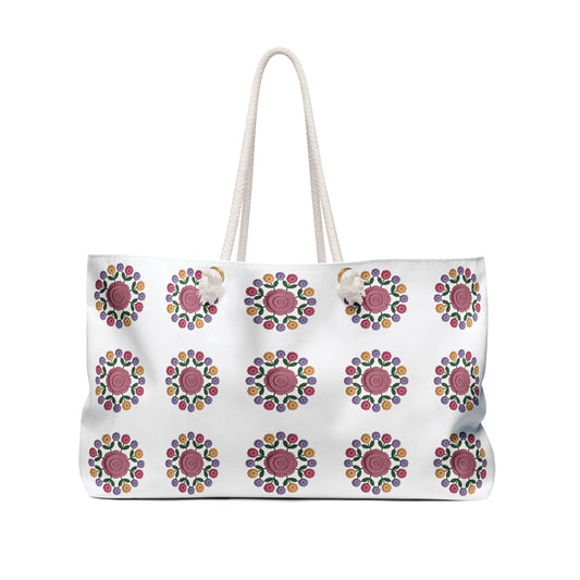 Crochet Floral Weekender Bag showcasing an intricate crochet floral pattern, perfect for weekend trips, with rope handles and a spacious interior, embodying FireBrook Designs' commitment to style and joy.