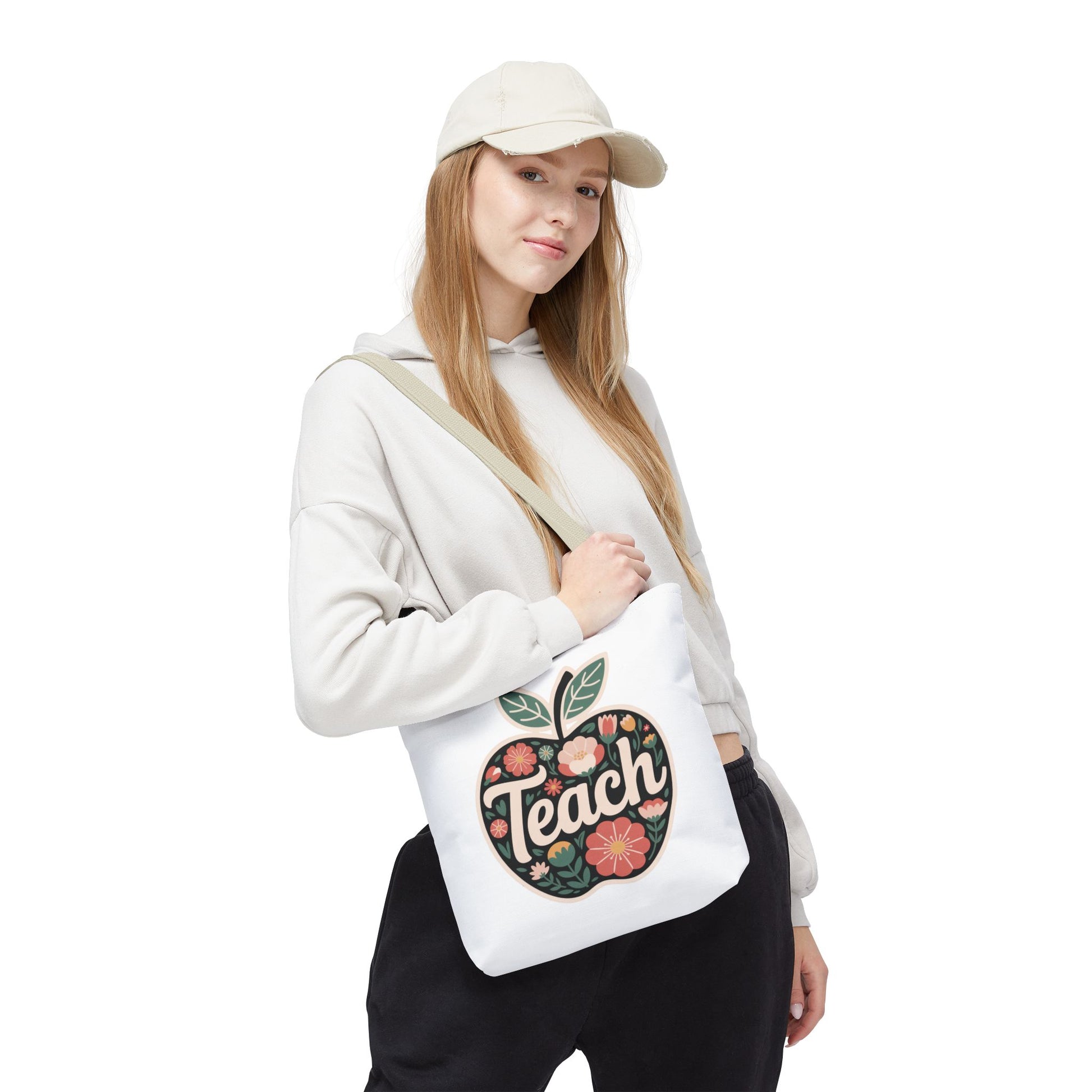 Floral Apple Tote Bag - Hand-Drawn Pastel-Colored Design with 'TEACH' features an apple-shaped design with pastel floral illustrations. Ideal for educators, it blends style and practicality, embodying FireBrook Essentials' uplifting spirit.