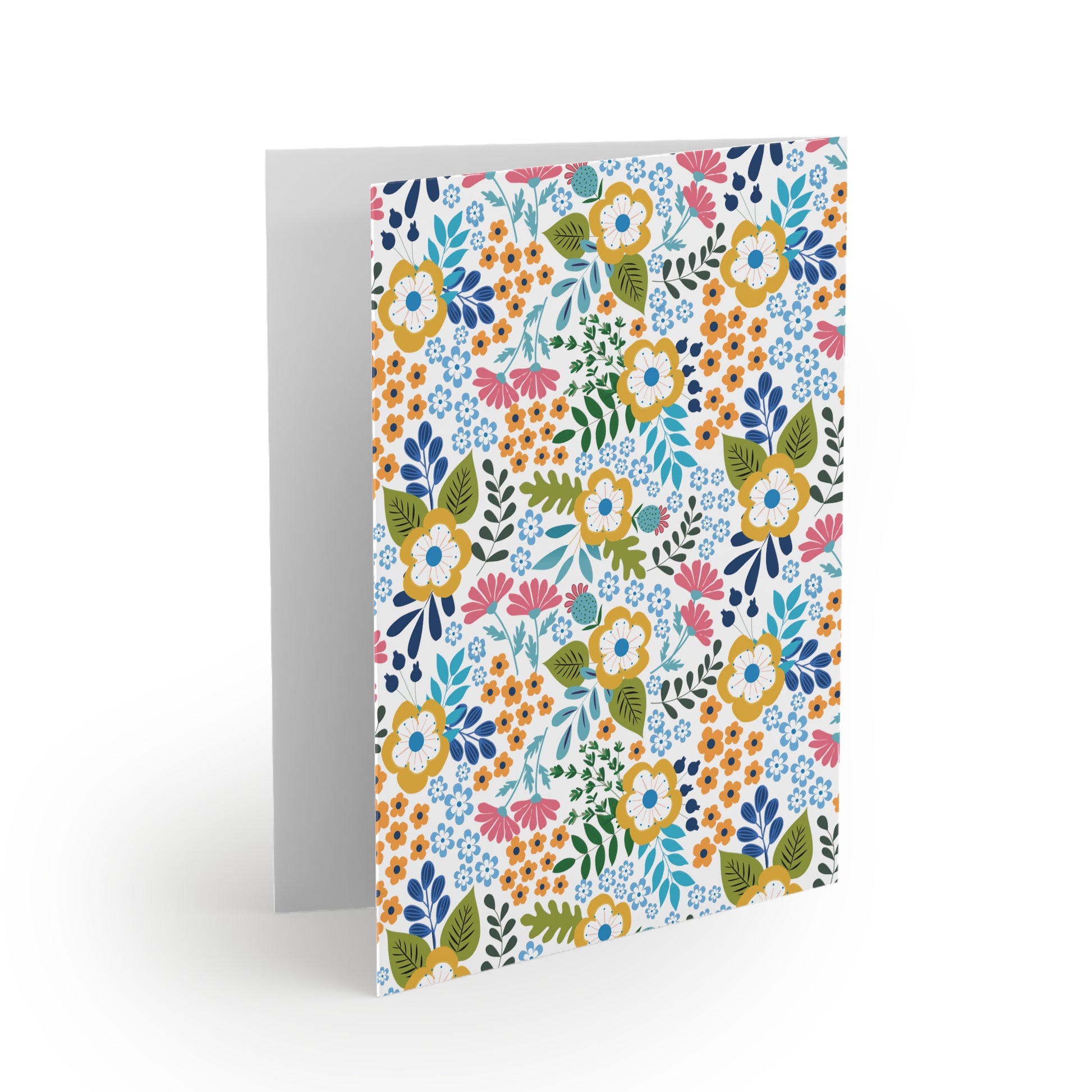 Wildflower Greeting Cards — Pack of 8/16/24: A folded card with vibrant hand-drawn wildflowers in yellow, pink, orange, and blue on a white background, exuding fresh, springtime energy. Blank inside for personal messages.