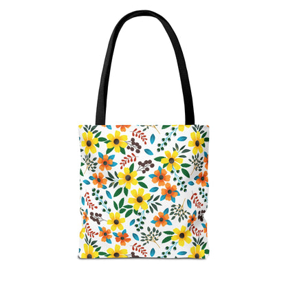 Floral Tote Bag with black straps features a vibrant pattern of yellow and orange blossoms, green leaves, and red sprigs on white. Perfect for summer outings, embodying FireBrook Designs' joyful, uplifting style.