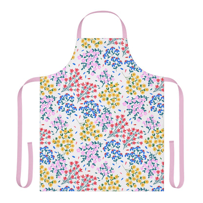 Floral Apron featuring vibrant red, pink, yellow, and blue blossoms with green foliage on a white background, accented by pale pink straps. Made from 100% polyester for comfort and stain resistance.