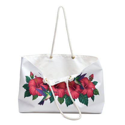 Tote Bag with hummingbirds and hibiscus design, featuring a close-up of a flower and sturdy rope handles with gold metal grommets, ideal for stylish weekend getaways and travel.