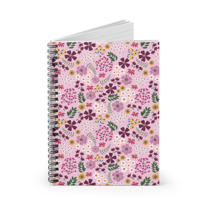 Floral Spiral Notebook with a vibrant floral cover, featuring purple, magenta, white, and yellow flowers on pale pink. Ideal for creative expression with smooth-turning metal binding and lined pages peeking through.