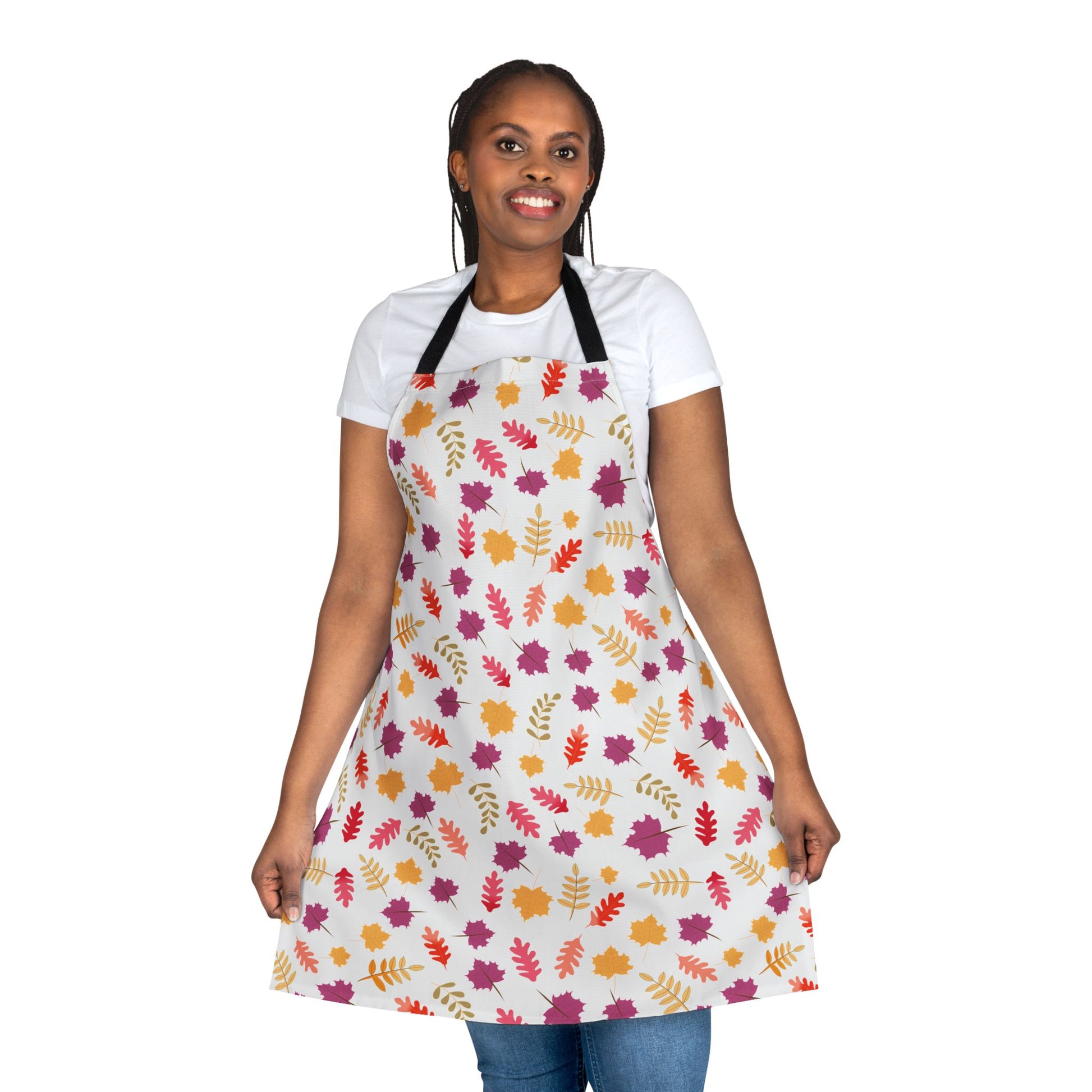 The Apron Floral Design showcases an autumn-leaf pattern on a light-colored, full-coverage apron, worn over a plain white T-shirt, embodying FireBrook Essentials' blend of comfort and uplifting style.