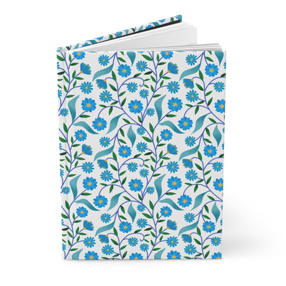 HARDCOVER JOURNAL, MATTE, RULED, 5X7, SEWN BIND, CLEAN-TEAR PAGES – BLUE DAISY VINE features a floral-patterned cover with blue blossoms, perfect for inspiring joyful writing or sketching.