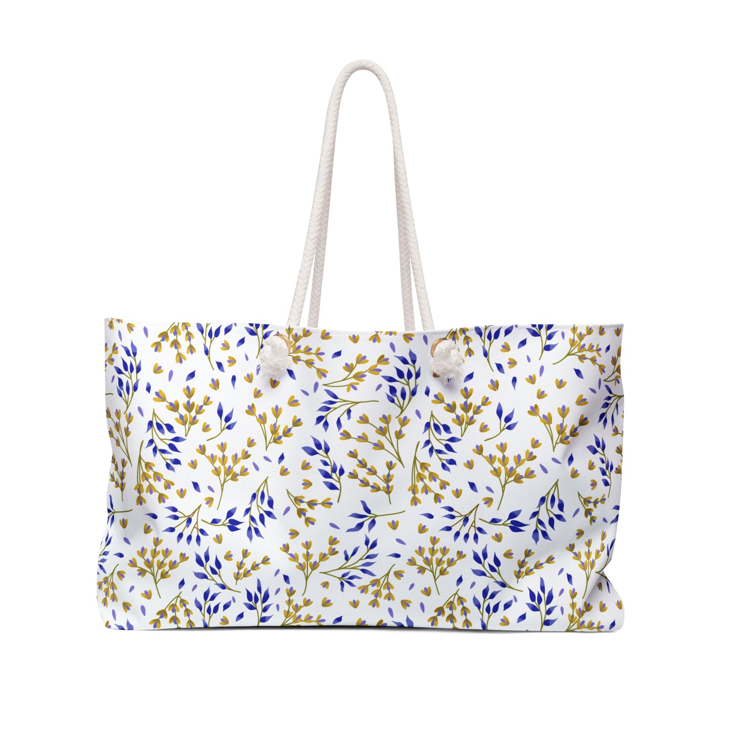 Weekender Bag made from white canvas-like material, featuring knotted rope handles and a botanical pattern of blue and mustard-yellow sprigs, perfectly embodies FireBrook Essentials' stylish, travel-ready design ethos.