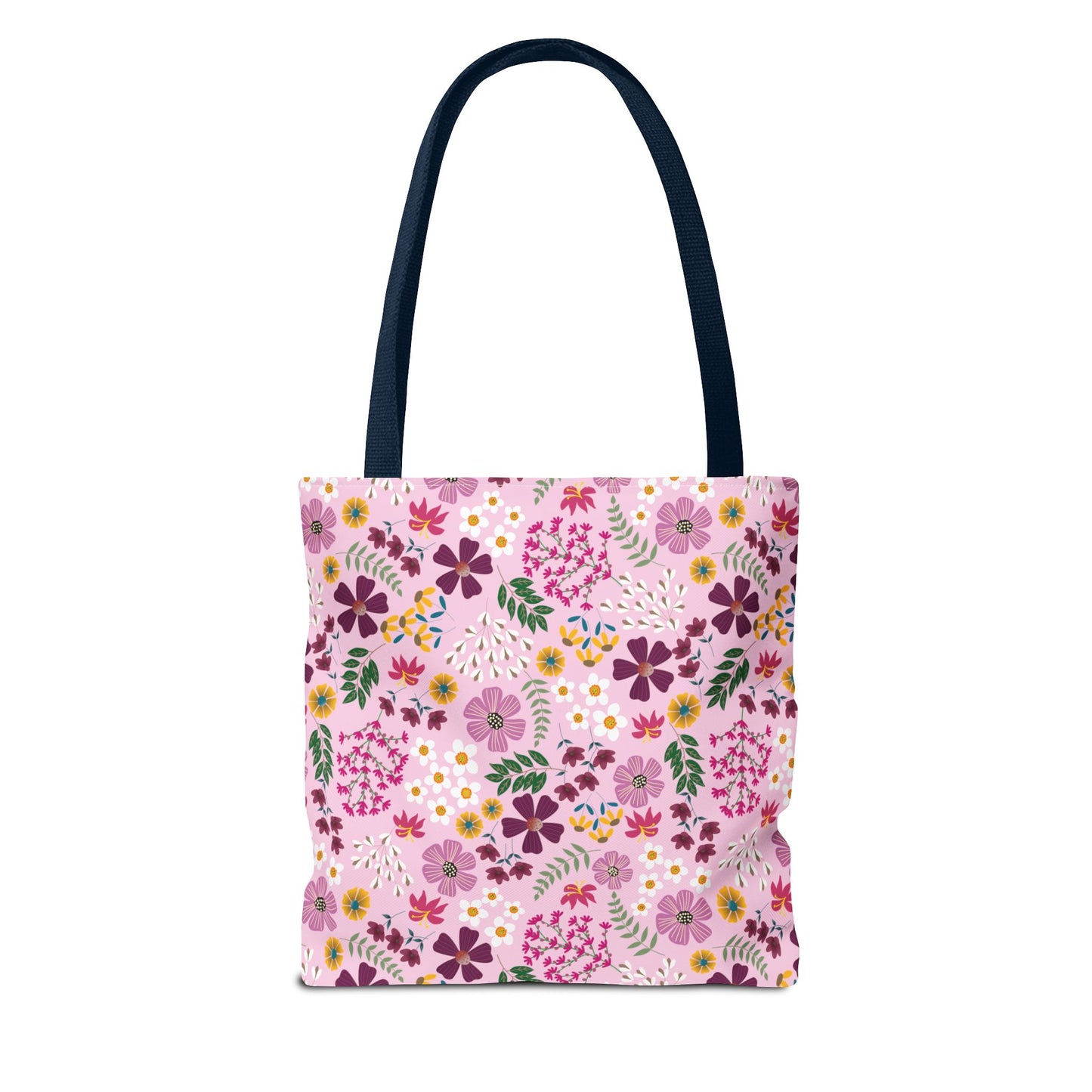Rose Garden Blush Tote Bag features a pink floral pattern with purple, magenta, yellow, and white blossoms. It has a dark-navy handle, perfect for everyday use with durable, reinforced construction.