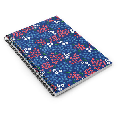 Floral Spiral Notebook featuring a deep blue cover with stylized red and light-blue floral clusters, bound with black wire, embodies FireBrook Designs' cheerful and creative essence, ideal for note-taking and sketching.