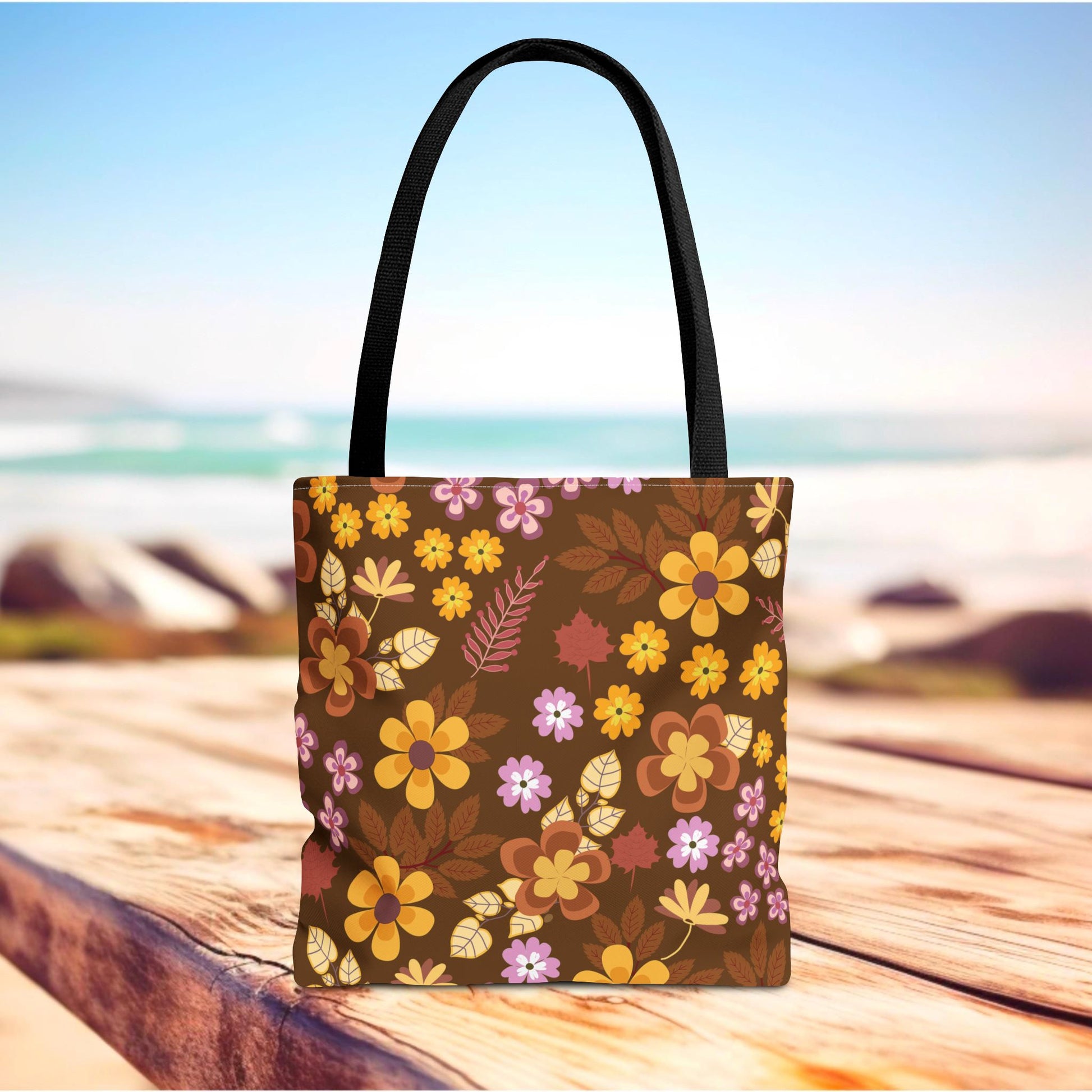 Floral Tote Bag on a wooden surface, featuring a retro floral pattern in warm tones. Perfect for summer outings, with durable polyester, reinforced handles, and ample space, embodying FireBrook Essentials' joyful design ethos.