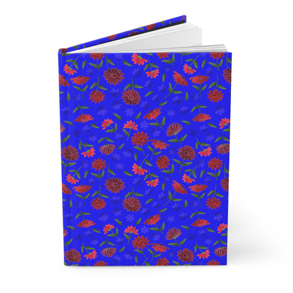 Floral Night Sky Hardcover Journal — Blue & Red Botanical Notebook features a cobalt-blue cover with red and pink daisies, revealing blank white pages. Perfect for vibrant, inspiring journaling.
