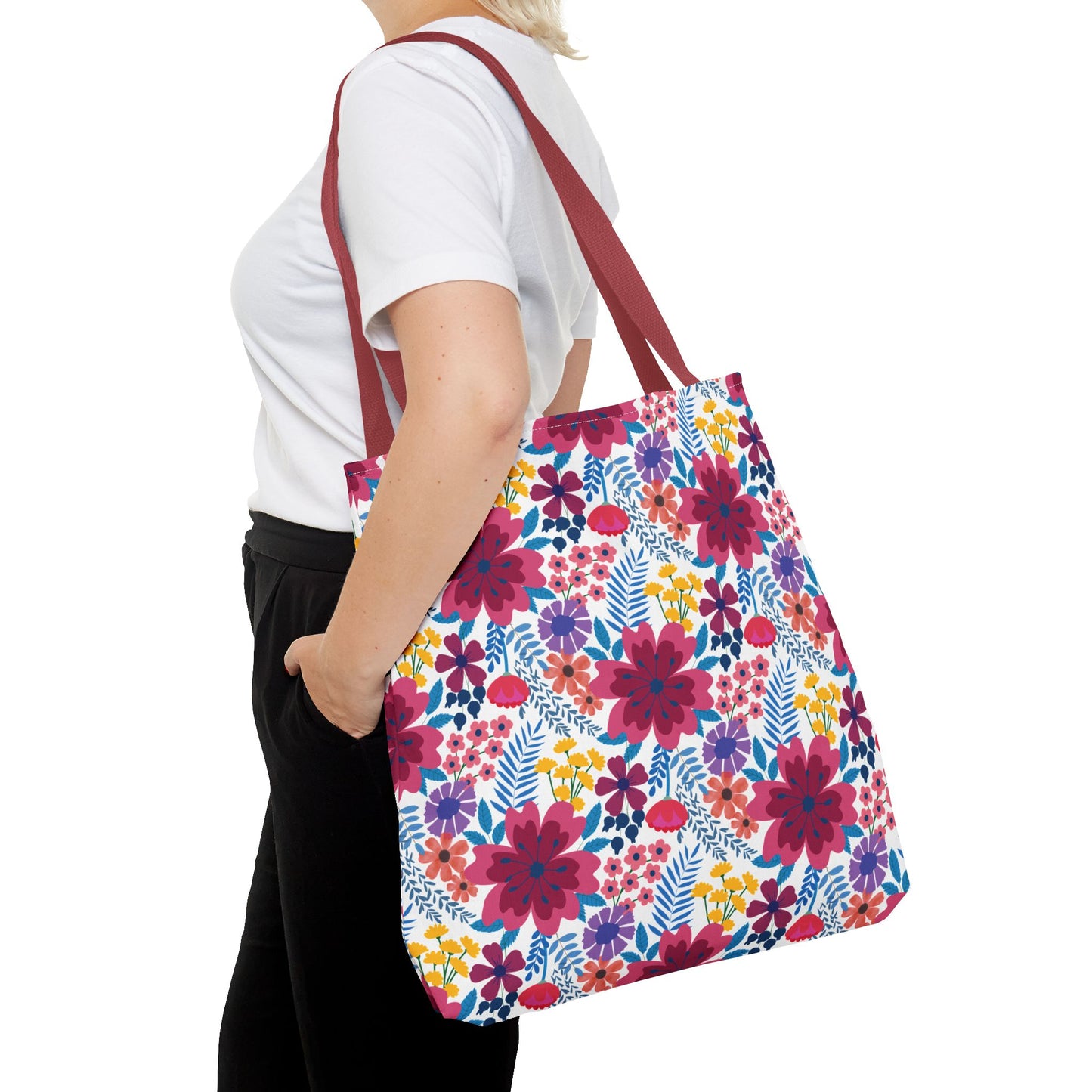 Floral Tote Bag with vibrant pink, purple, yellow, and blue flowers on a white canvas, featuring burgundy straps. Ideal for cheerful outings, showcasing FireBrook Essentials' uplifting design style.