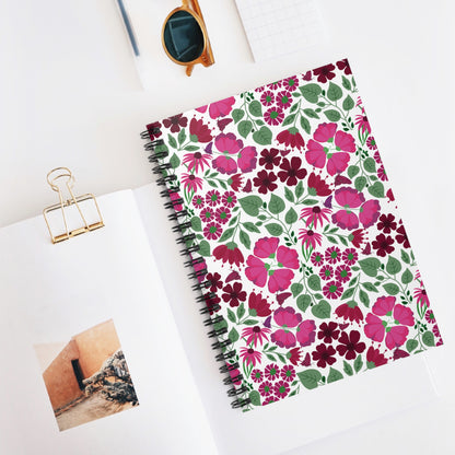Floral Spiral Notebook elegantly displayed in a flat-lay scene, showcasing its vibrant floral cover and sleek metal binding, perfect for creative note-taking. Nearby, sunglasses and a binder clip complete the stylish setup.