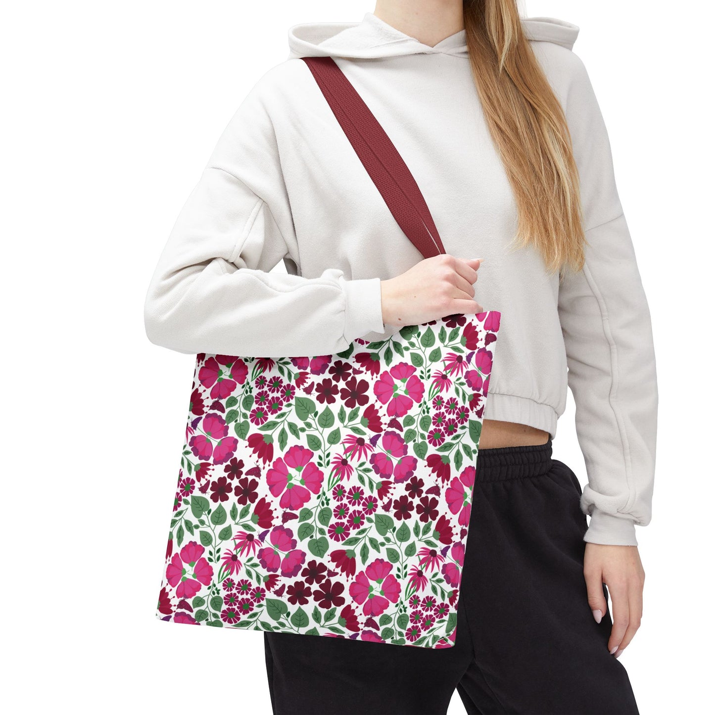 Person holding a Pink Lady Tote Bag featuring vibrant pink and berry floral prints on a white background, embodying FireBrook Designs' uplifting style. Perfect for daily errands or adding color to outfits.
