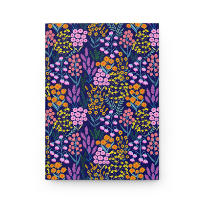 HARDCOVER JOURNAL, MATTE, RULED, 5X7, SEWN BIND, CLEAN-TEAR PAGES - FLORAL MEADOWS features vibrant wildflower patterns on a navy background, offering a durable, stylish notebook for joyful, everyday use.