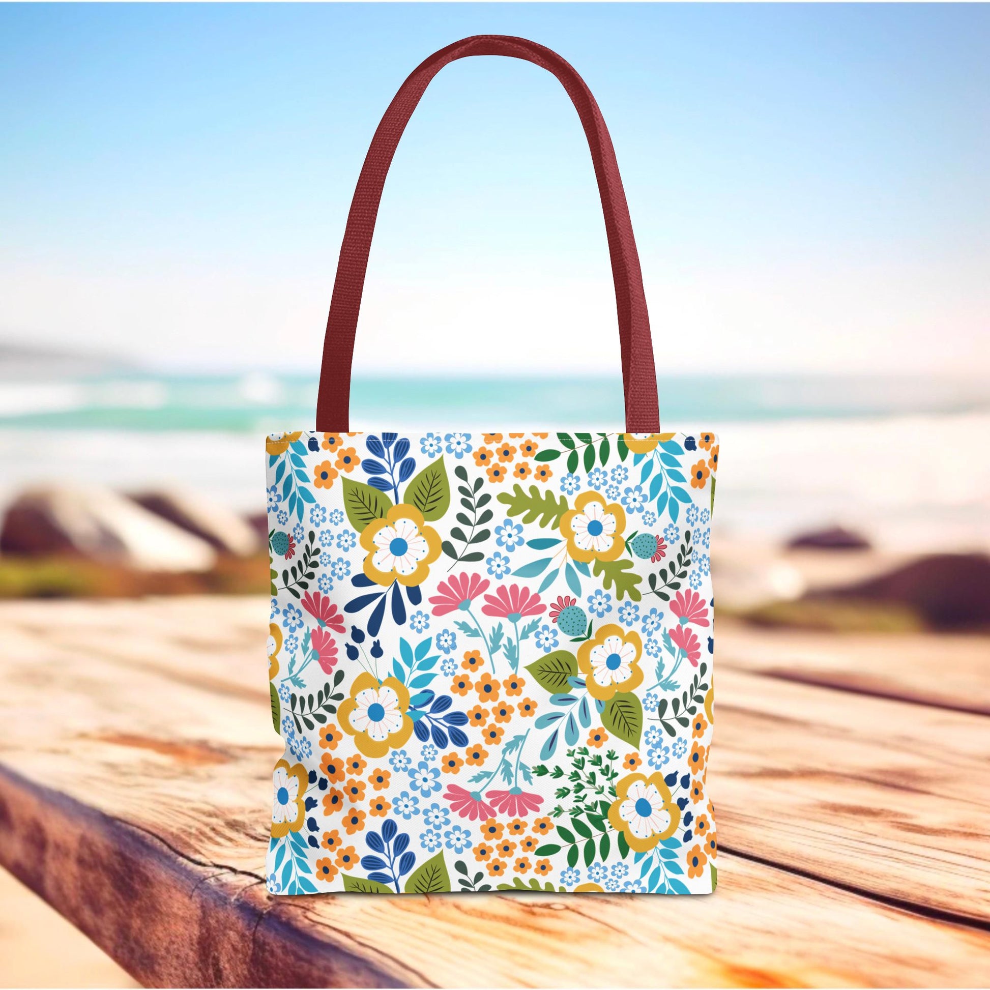 Floral Tote Bag featuring vibrant ditsy flowers with green leaves, solid maroon straps, perfect for summer outings. Crafted for durability, embodying FireBrook Essentials' joyful and stylish design ethos.