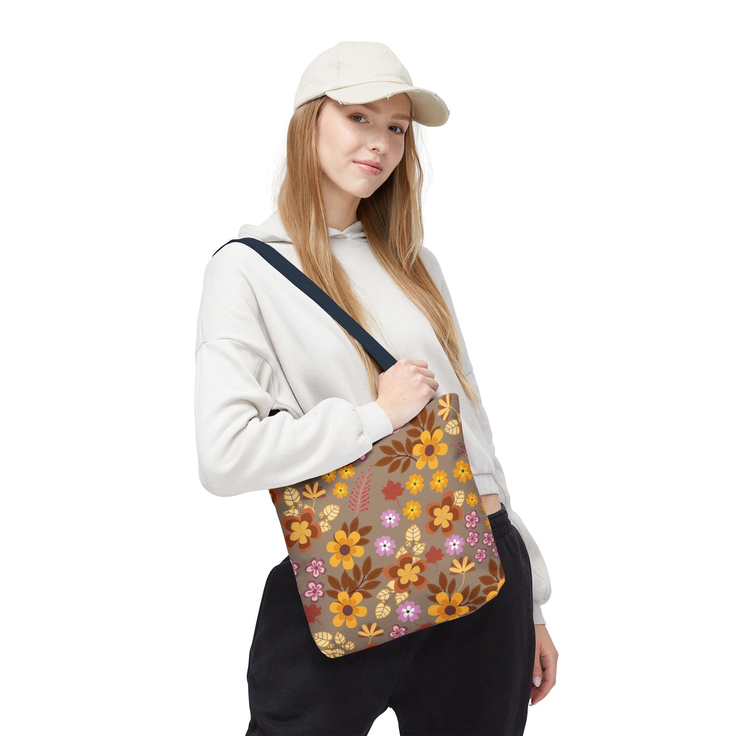 Young person in beige hoodie with Harvest Brown Bloom Tote Bag, featuring autumnal floral pattern and navy strap, embodying FireBrook Designs' joyful style for versatile, cheerful outings.