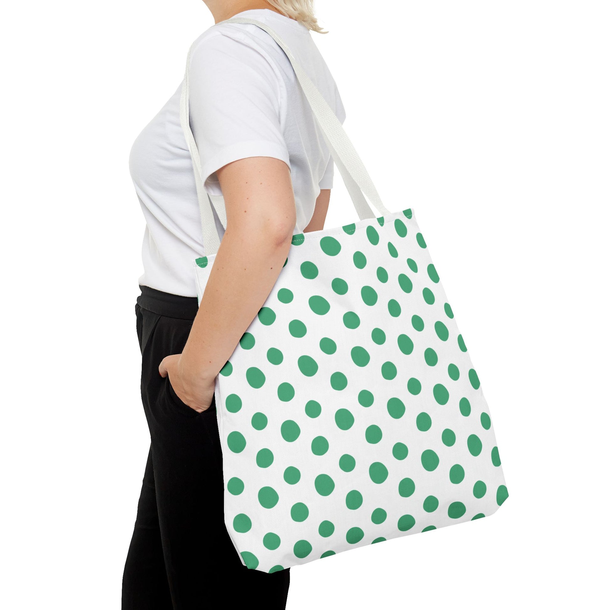 Green Polka Dots Tote Bag held by a woman, showcasing its playful polka dot pattern. Ideal for adding a cheerful pop of color to any outfit, embodying FireBrook Designs' joyful and stylish aesthetic.