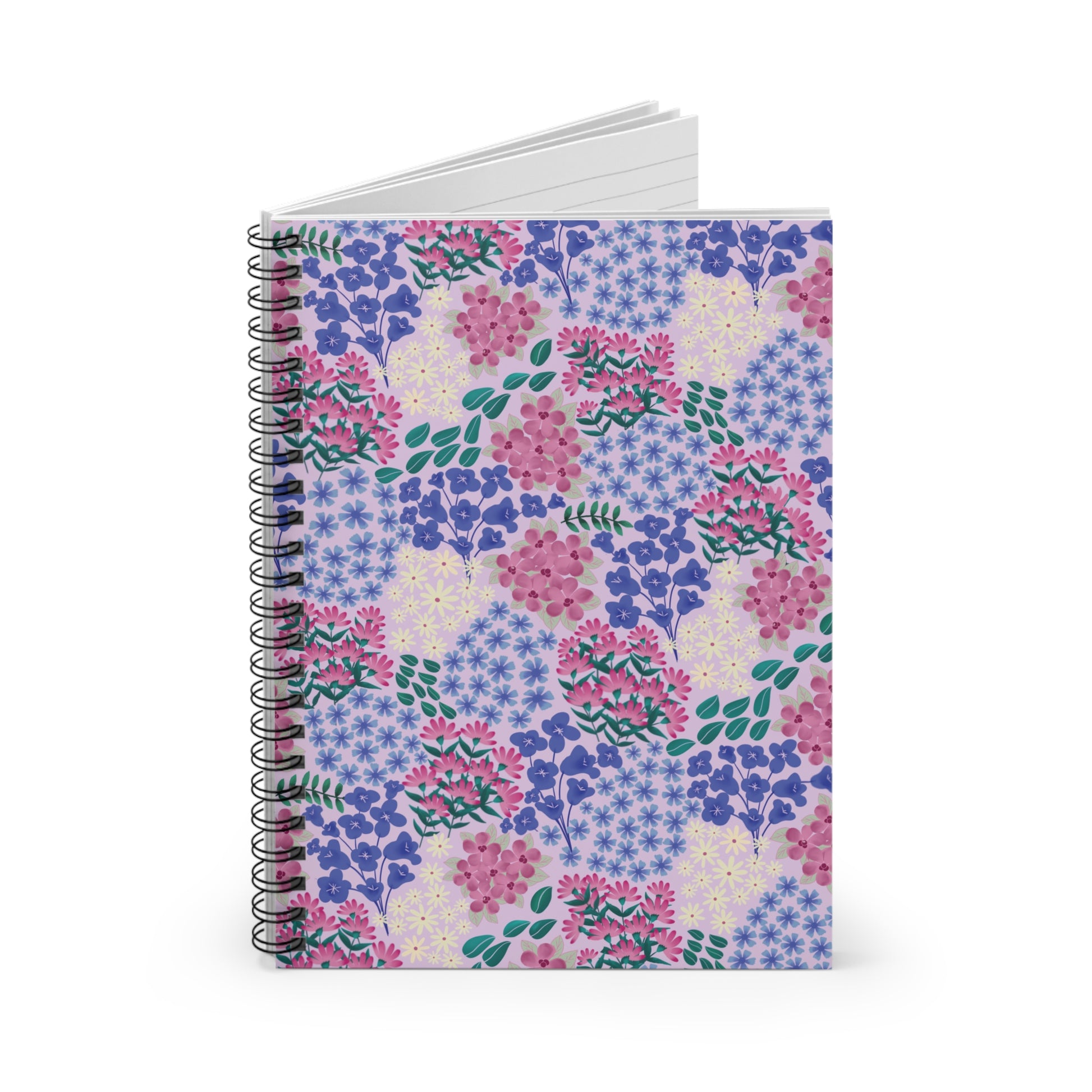 Floral Spiral Notebook with vibrant purple, pink, blue, and green floral pattern on a pale background, showcasing white lined pages, reflecting FireBrook Designs' blend of style and functionality.