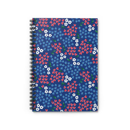 Floral Spiral Notebook featuring a dark blue cover with vibrant white flowers, red petals, and blue and green leaves. Ideal for creativity and organization, it embodies FireBrook Designs' uplifting style.
