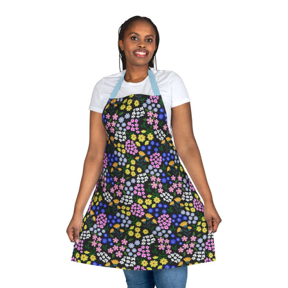 Person wearing Apron Floral Design with vibrant floral pattern and light blue straps, showcasing FireBrook Essentials' stylish, comfortable apparel. Ideal for cooking or crafting, reflecting joyful, uplifting design ethos.