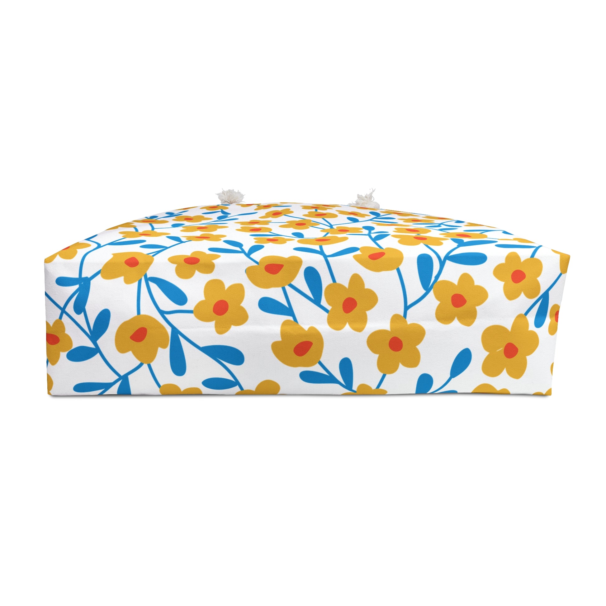 Weekender Bag featuring a vibrant white fabric with yellow floral patterns and blue stems, complemented by rope handles for easy carrying. Perfect for stylish, comfortable travel.