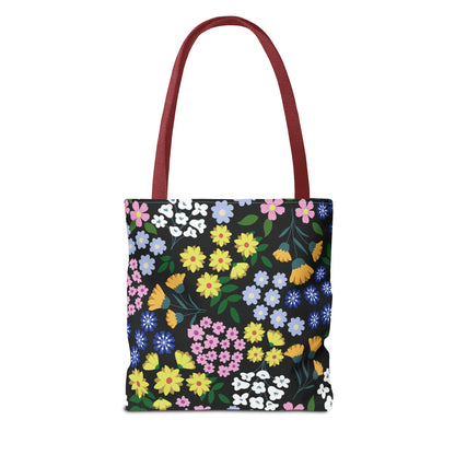 Starry Night Blooms Tote Bag features vibrant floral patterns on a black canvas-style body with burgundy-red handles, ideal for cheerful summer outings and adding joy to everyday activities.
