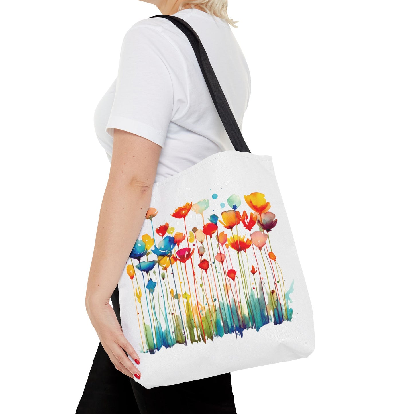 Watercolor Floral Tote Bag held by a woman, featuring vibrant flower designs. Perfect for errands or travel, combining style and functionality for daily use.