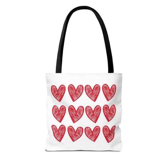 Hearts Tote Bag featuring a white base adorned with red hearts, embodying FireBrook Essentials' uplifting style. Designed with reinforced handles and boxed corners for durability and space, perfect for adding love to any outfit.