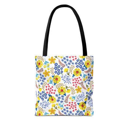Floral Tote Bag featuring a vibrant, multicolored floral pattern on a white base with black handles, perfect for summer outings. Durable polyester with reinforced stitching ensures longevity, blending style and practicality.