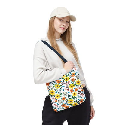 A young woman models the Sunny Meadow Mix Tote Bag by FireBrook Designs, featuring vibrant yellow and orange floral patterns, perfect for brightening summer outings, farmers markets, or beach trips.