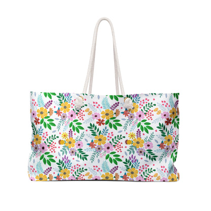 Weekender Bag with a bright floral-and-foliage pattern and thick rope handles, featuring a spacious 24 x 13 design and luxurious cream interior, perfect for stylish travel.