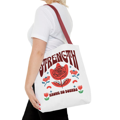 Strength Knows No Bounds Tote Bag carried by a woman, featuring a red rose design, ideal for everyday use and gifting, from FireBrook Essentials.