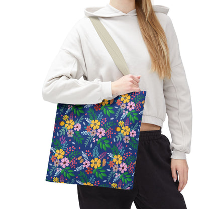 Floral Tote Bag with a vibrant navy blue body adorned with clusters of colorful flowers and leaves, featuring a natural-colored shoulder strap. Ideal for joyful, stylish summer outings, reflecting FireBrook Essentials' uplifting design ethos.