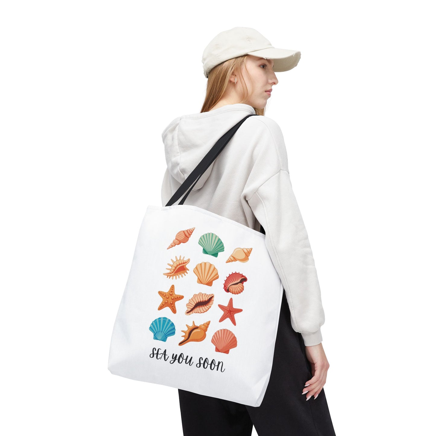 Sea You Soon Sea Shells Tote Bag featuring a beachy design with sea shells, perfect for summer outings. Durable 100% polyester body with reinforced handles, ideal for ocean-loving, coastal living enthusiasts.