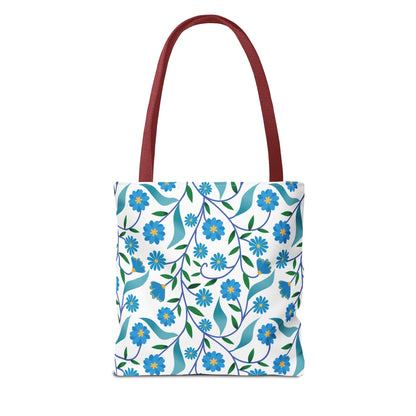 Blue Floral Tote Bag with long red handles, featuring a vibrant pattern of blue flowers and green leaves on a white background, embodies FireBrook's joyful and stylish design ethos, perfect for summer outings.