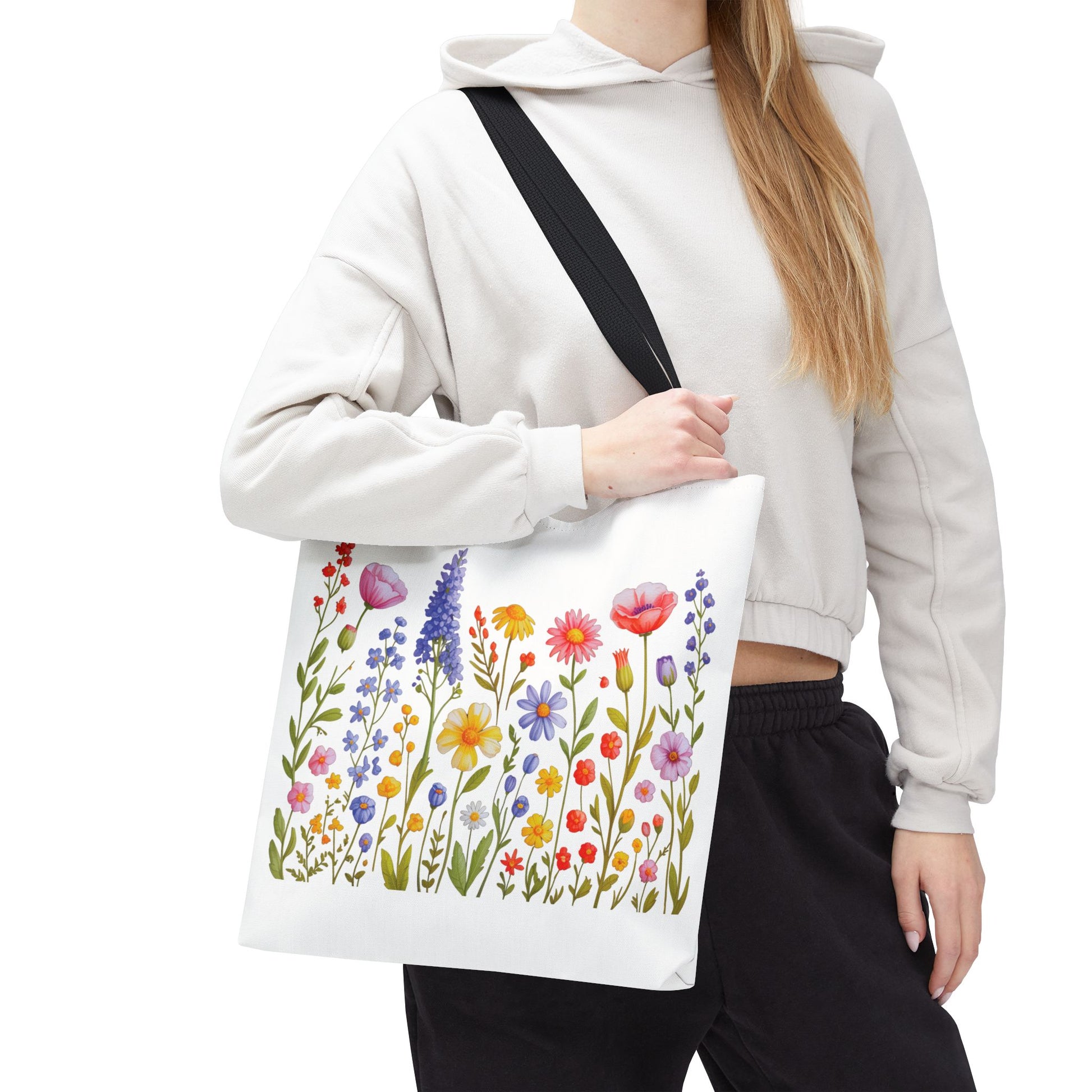 Wildflowers Tote Bag features a vibrant wildflower design, embodying a natural, free-spirited essence. Durable polyester build, reinforced handles, and spacious boxed corners make it ideal for everyday adventures.