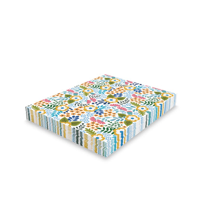 Wildflower Greeting Cards — Pack of 8/16/24 features vibrant floral prints on a neat stack of square napkins, perfect for adding a cheerful, springtime touch to any occasion.