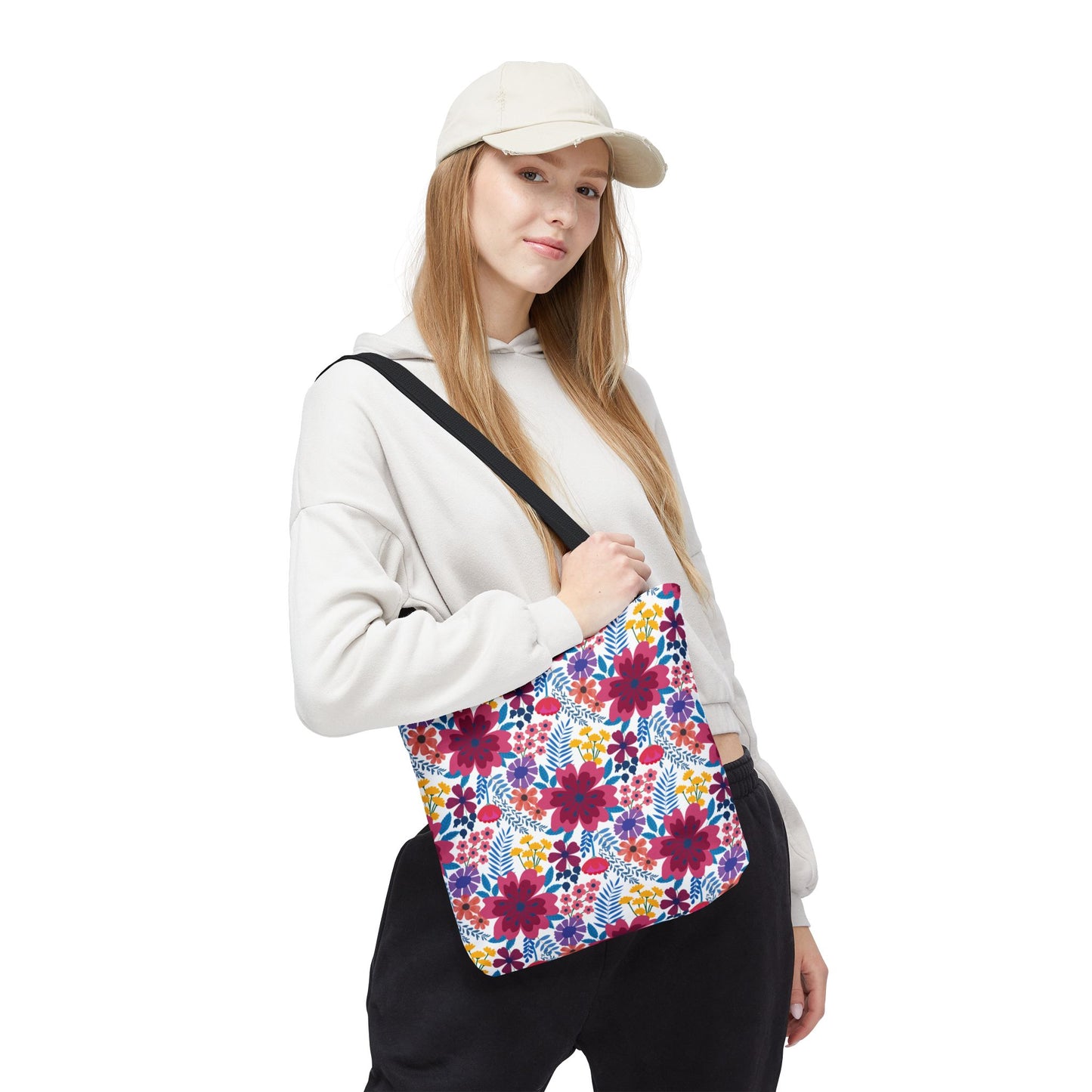 Young woman models the Violet Daisy Carnival Tote Bag from FireBrook Designs, showcasing its vibrant floral pattern. This spacious, durable tote is ideal for summer outings, aligning with the store's uplifting, joyful ethos.
