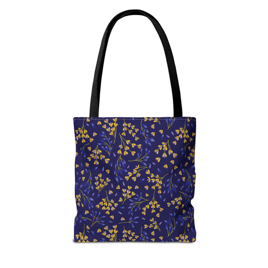 Floral Tote Bag showcasing a deep navy blue canvas with vibrant yellow and blue leaf clusters, featuring black straps and reinforced stitching, perfect for brightening summer outings with its cheerful design.