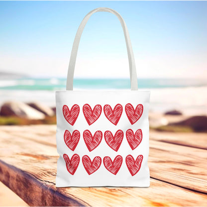 Hearts Tote Bag featuring red heart patterns, embodying FireBrook Designs' joyful and uplifting style. Ideal for adding charm to everyday outfits with its spacious design and durable polyester body.