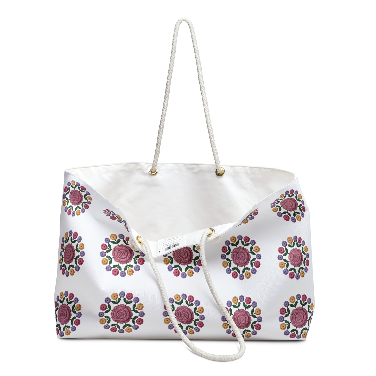 Crochet Floral Weekender Bag: A close-up of a stylish crochet floral pattern on a cream-colored background, highlighting its spacious design and comfortable cotton rope handles, perfect for weekend getaways.