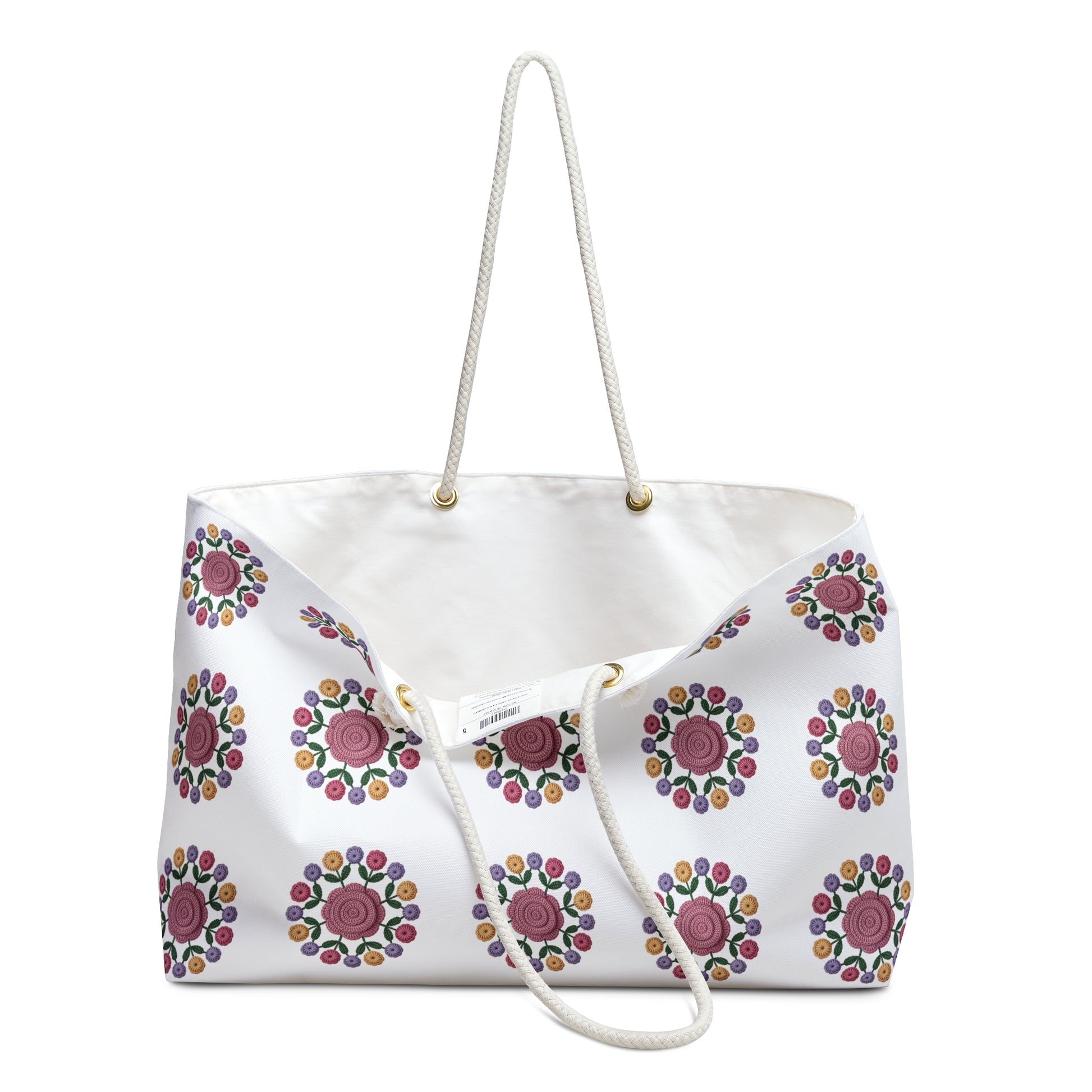 Crochet Floral Weekender Bag: A close-up of a stylish crochet floral pattern on a cream-colored background, highlighting its spacious design and comfortable cotton rope handles, perfect for weekend getaways.